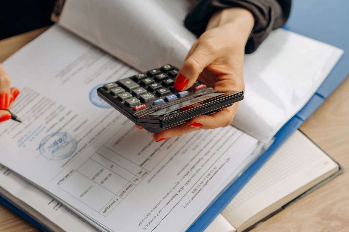 Reviewing credit statements with a calculator to work out repair costs