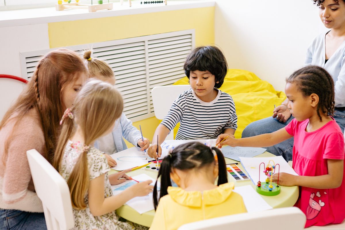 Children doing art together at a table, where group size becomes visible