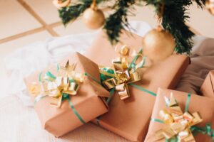 Wrapped Christmas gifts stacked under a decorated tree