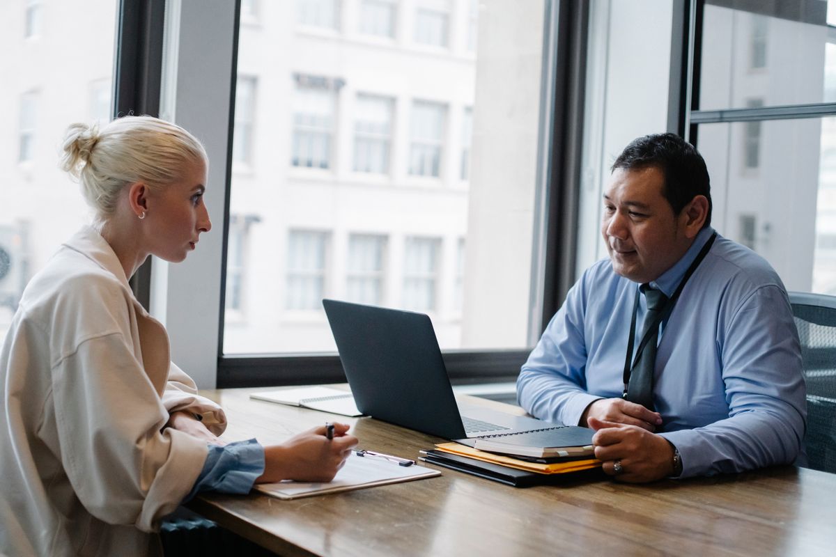 An initial consultation across a desk, where you interview the lawyer as much as they assess you