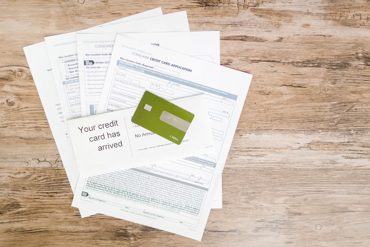 Credit card resting on application paperwork during a credit review