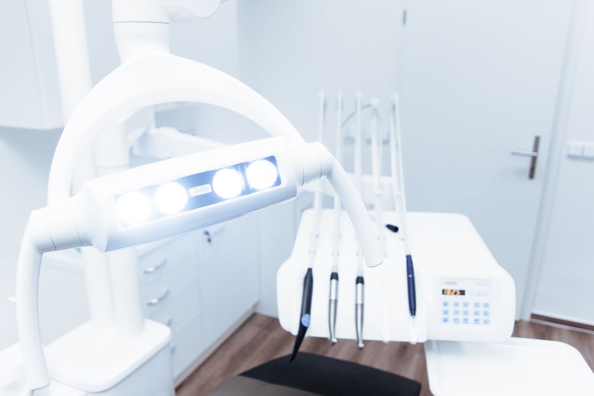 Clean modern dental surgery room with a treatment chair and equipment
