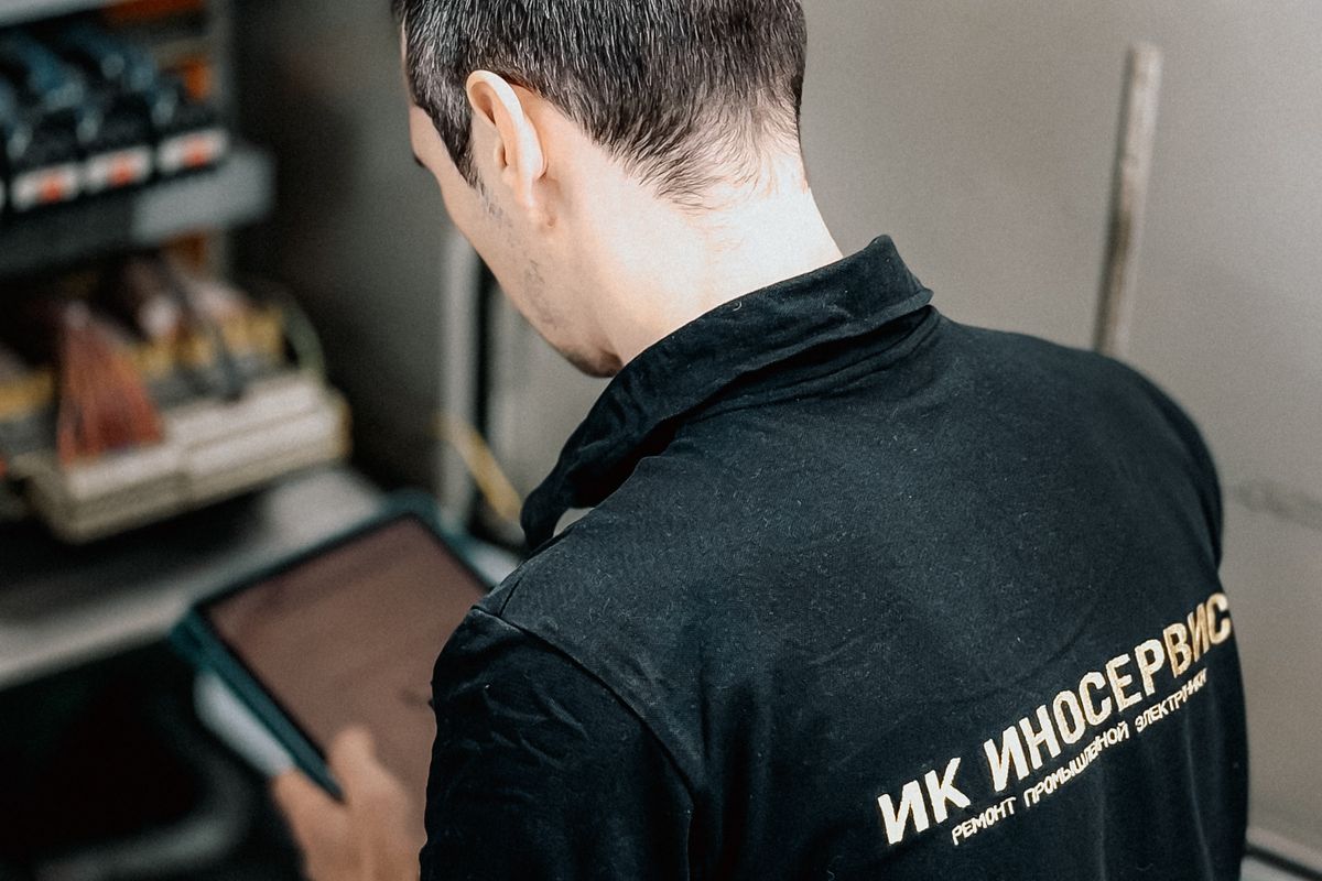 Electrician checking the breakers and wiring inside a home circuit panel