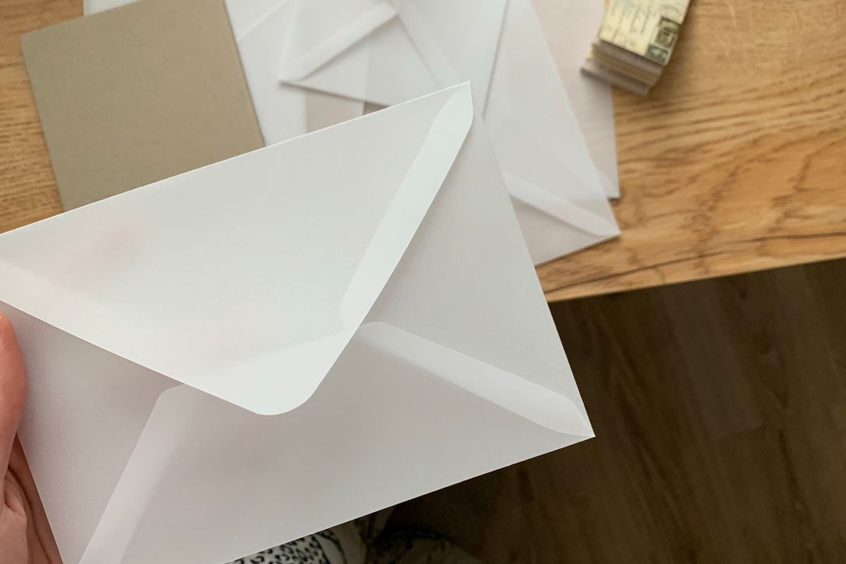 Envelopes and writing paper laid out for posting a written credit dispute letter