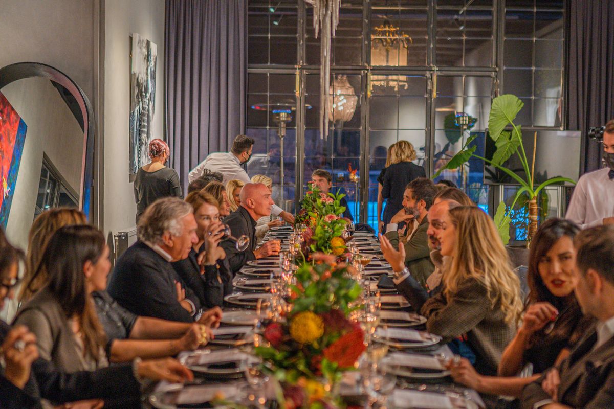 Guests seated at a formal catered dinner, where per-head costs are highest