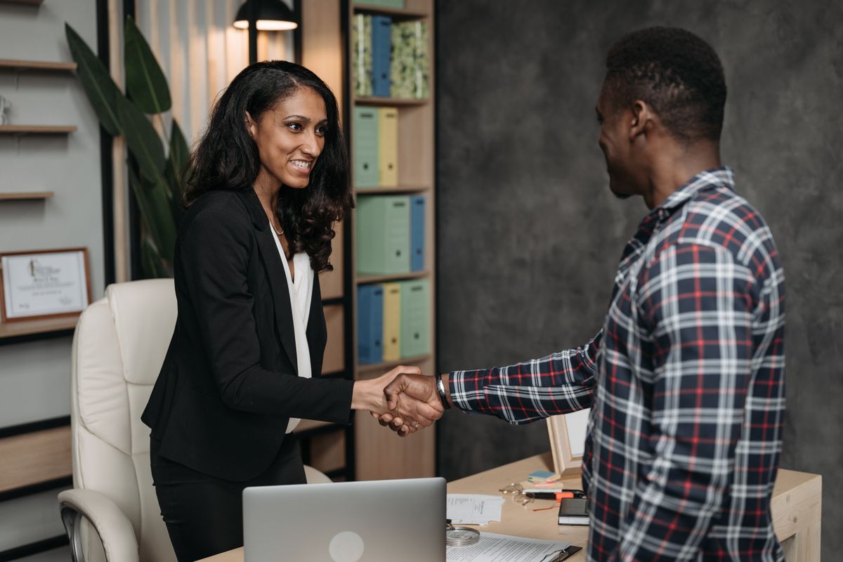 Lawyer and client shaking hands after agreeing written fee terms