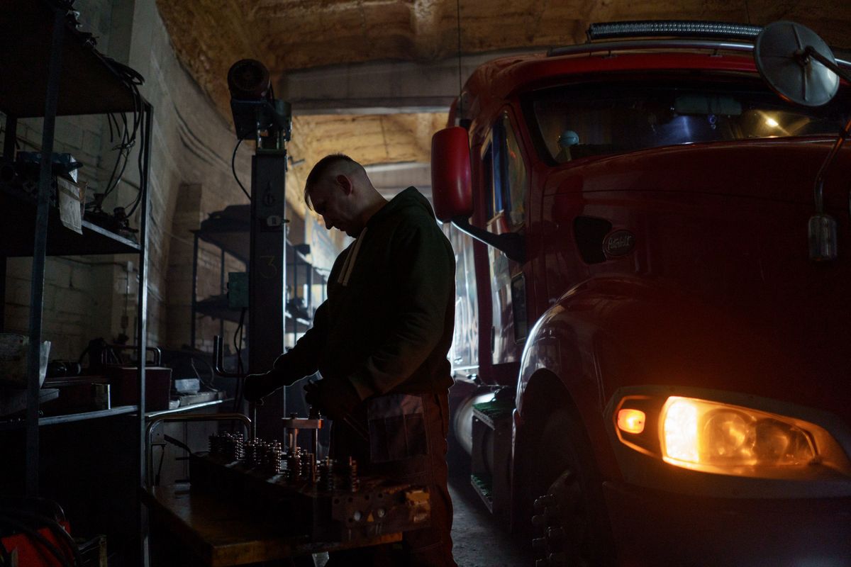 A mechanic at work in a service bay, where certification and experience show