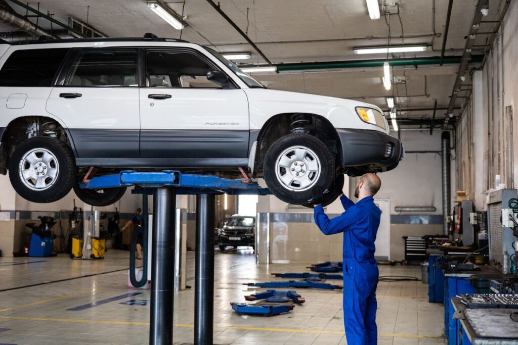 A mechanic inspecting a vehicle at an auto repair shop