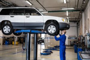 A mechanic inspecting a vehicle at an auto repair shop