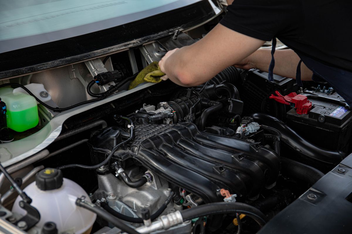 A technician carrying out a repair in a workshop bay