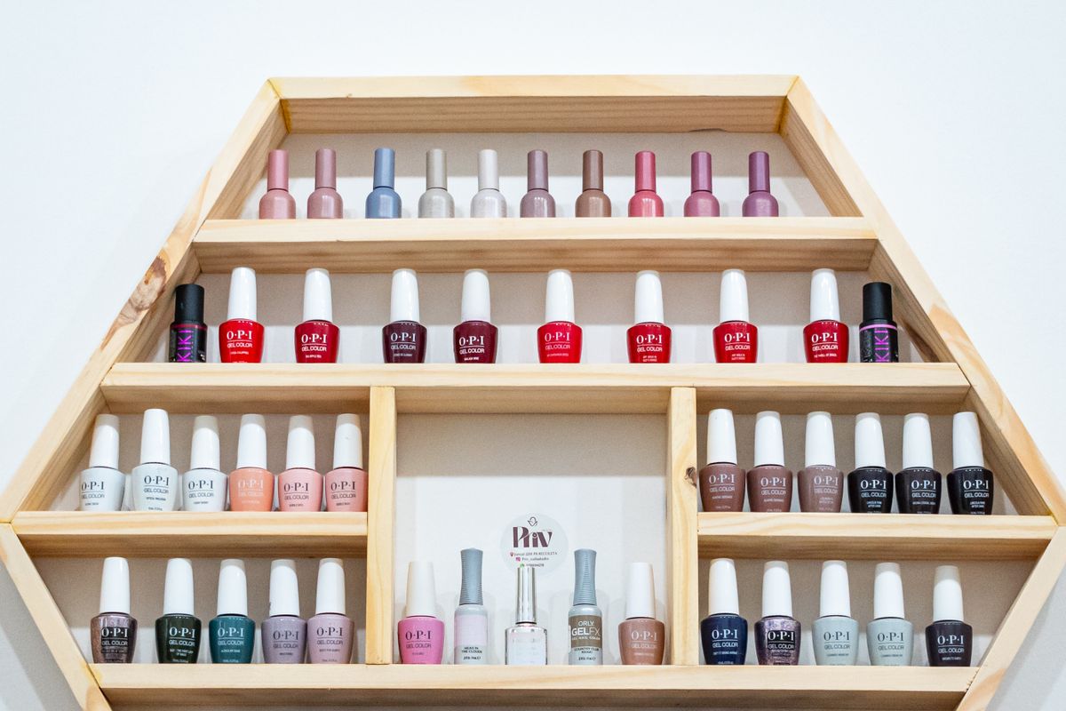 Shelf of colourful nail polish bottles displayed in a nail salon