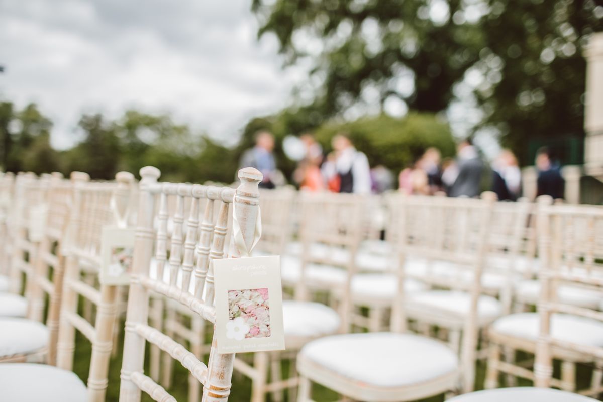 Chairs set out for an outdoor wedding ceremony at a garden venue