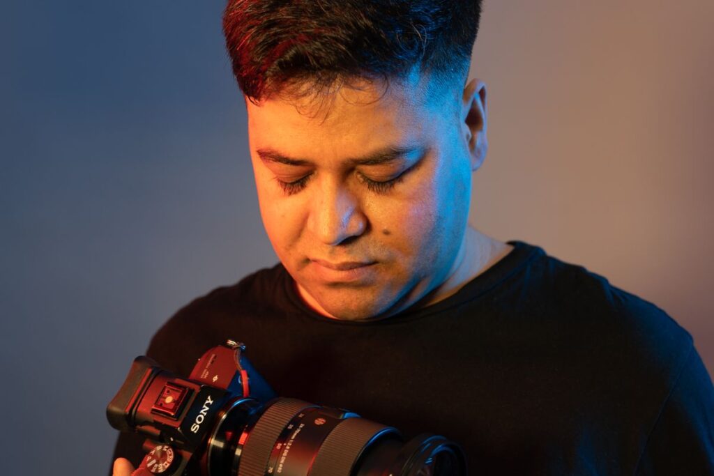 A professional photographer checking a camera before a shoot