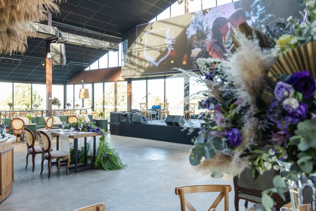 A reception hall laid out and decorated for a wedding dinner