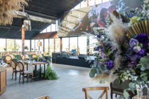 A reception hall laid out and decorated for a wedding dinner