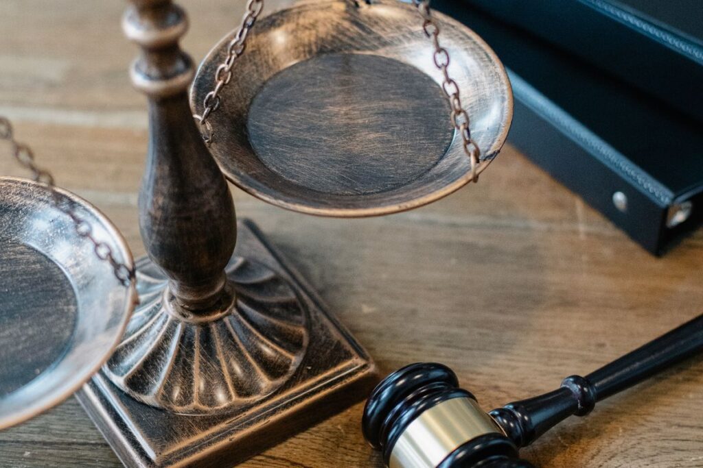 Scales of justice and a gavel on a desk representing personal injury legal fees