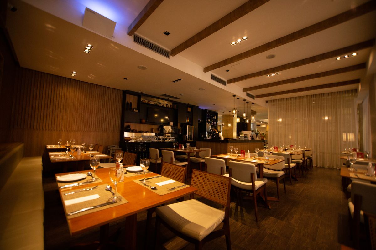 Set tables in a quiet restaurant, the kind of room that suits a conversation