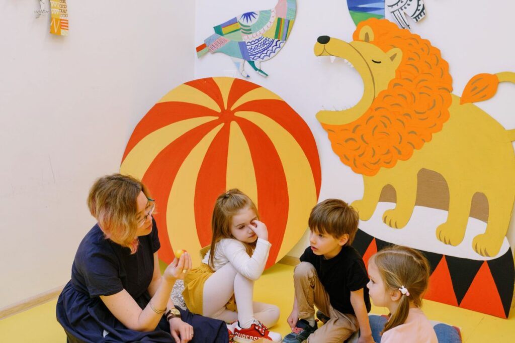 A teacher playing with a preschool child in a childcare setting