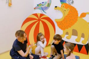 A teacher playing with a preschool child in a childcare setting