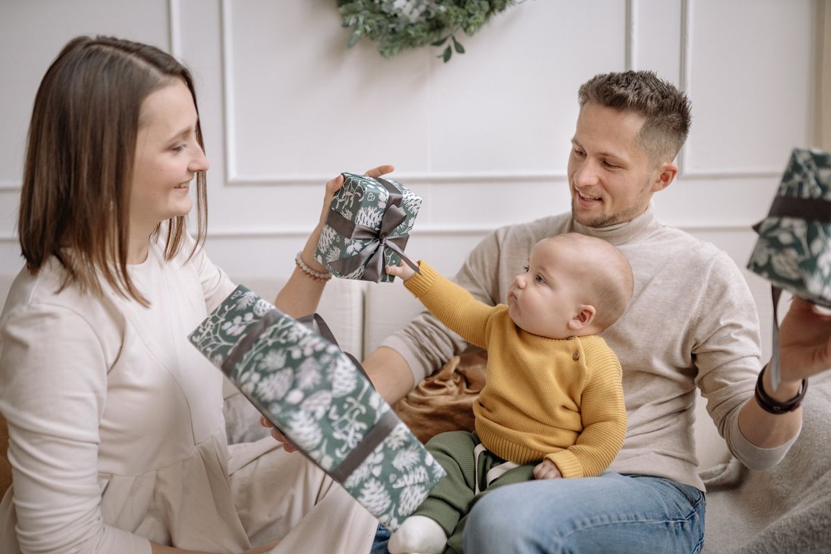 Opening a wrapped Christmas gift at home