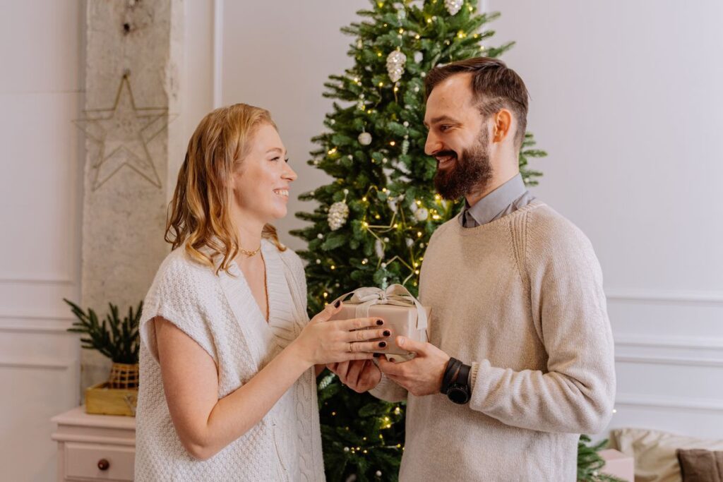 Family exchanging Christmas gifts at home