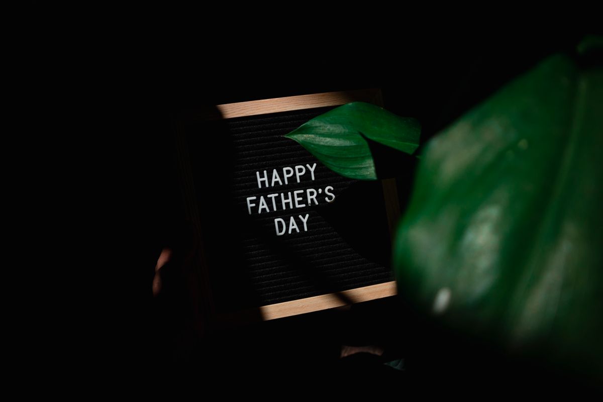 Father opening a wrapped Father's Day gift