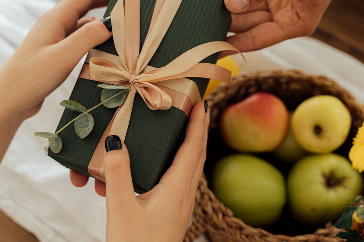 A wrapped housewarming gift on a table