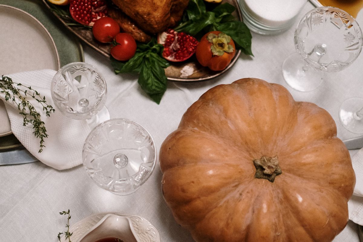 Guests gathered around a Thanksgiving table