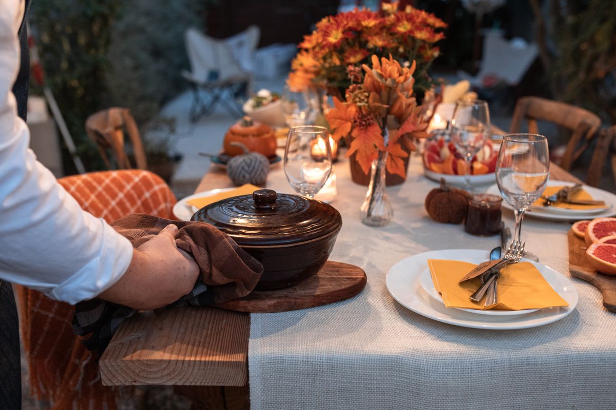 Guest arriving at a Thanksgiving dinner with a gift